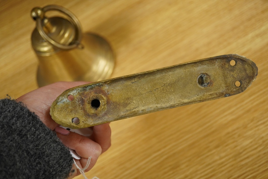 A brass bell with wall mount, 24cm high. Condition - good